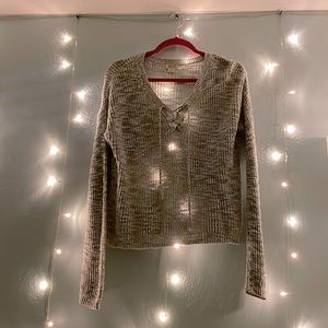 A gray V neck sweater